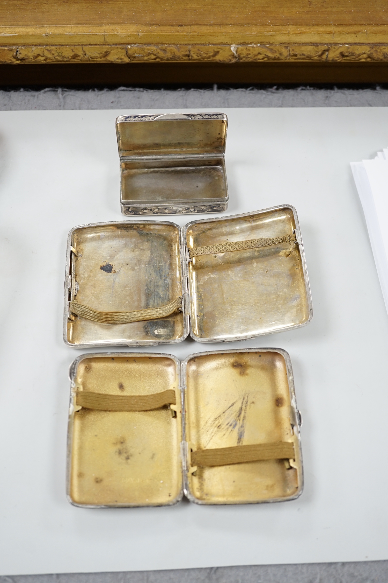 A white metal cigarette case, with applied dragon, 82mm, one other silver cigarette case and a Russian 84 zolotnik snuff box(tired).